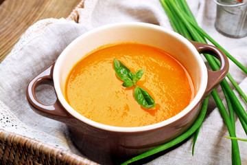Carrot cream-soup with vegetables on table close up