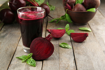 Glass of beet juice on wooden table, closeup