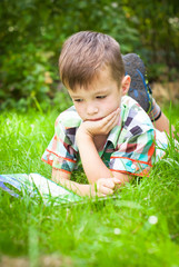 Little boy reading book