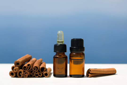 Aromatherapy essential oils in bottles and cinnamon sticks 