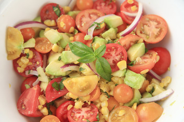 Corn, avocado, tomato and basil salad
