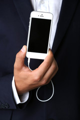 Music smartphone in businessman hand, close-up