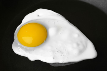 Scrambled egg on black pan background