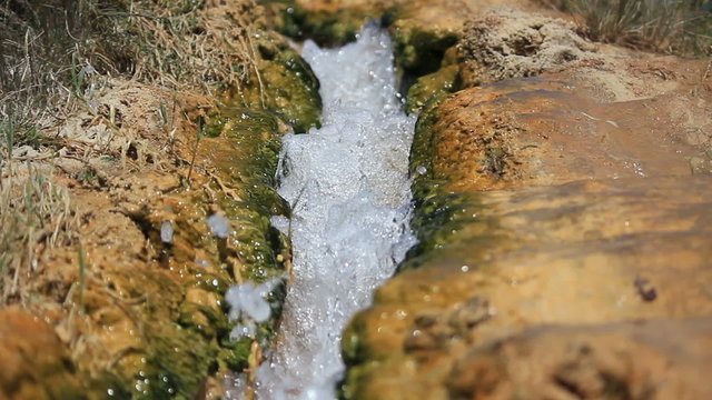 A hd clip of little creek flowing in a rocky scenery
