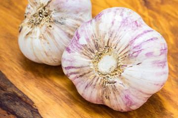 Organic garlic on wooden table background