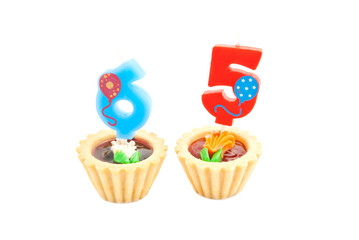 cakes with sixty five years birthday candles on white