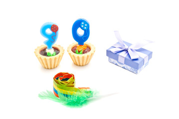 cakes with ninety years birthday candles, whistle and gift on wh
