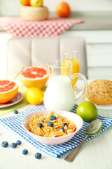 Healthy breakfast with fruits and berries on table in kitchen