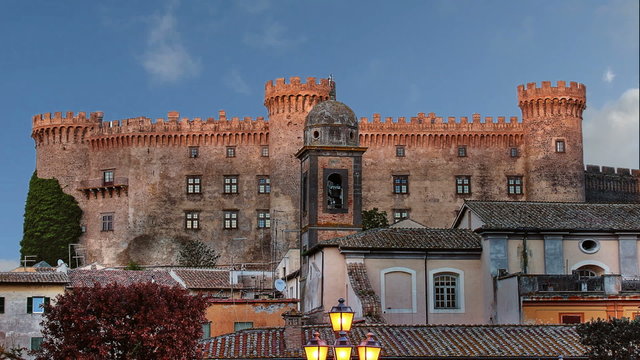 A zooming timelapse shot of historical centre of Bracciano, a nice village near to Rome, with Orsini-Odescalchi castle and fast clouds passage

