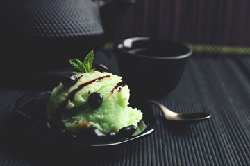 Homemade Green tea ice-cream on bamboo mat, on wooden background