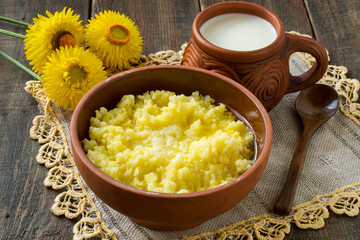 Millet porridge for breakfast with butter and milk