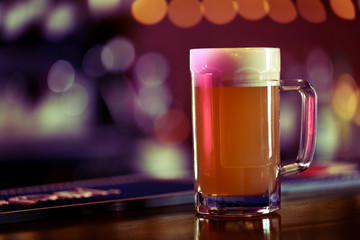 Cold beer glass on bar or pub desk