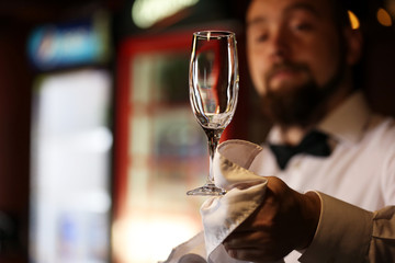 Bartender wipes glasses at work