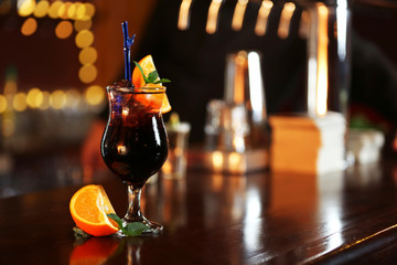 Cocktail on bar counter on bar background