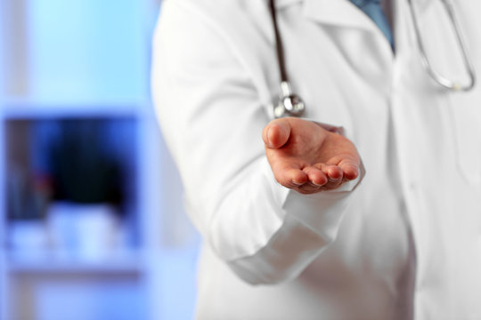 Doctor with digital tablet at his workplace