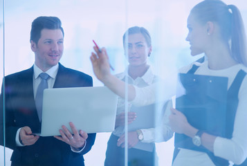 Group of  business people doing presentation with laptop during