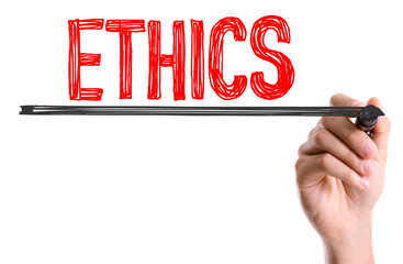 Hand with marker writing the word Ethics