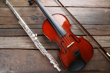 Fototapeta na wymiar Flute with violin on table close up