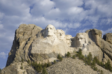 White puffy clouds behind Presidents George Washington, Thomas Jefferson, Teddy Roosevelt and...
