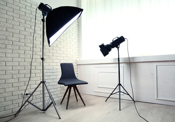 Photo studio with modern interior and lighting equipment