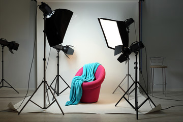 Photo studio with modern interior and lighting equipment