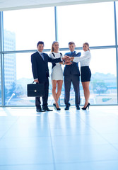 Fototapeta premium Business people with their hands together in a circle