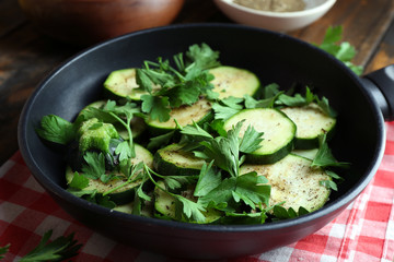 Sliced zucchini in pan on table, closeup