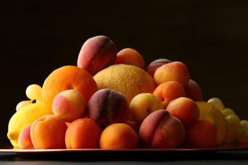 Heap of fresh fruits on dark background