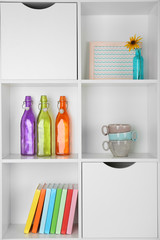 Beautiful white shelves with different home objects