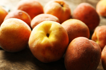 Ripe peaches on wooden background
