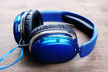 Headphones on wooden background