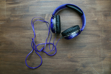 Headphones on wooden background