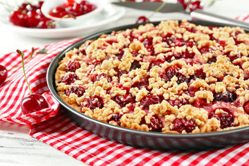 Tasty homemade pie with cherries on table close up