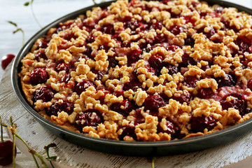 Tasty homemade pie with cherries on table close up