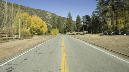Yellow stripes of road leading into Pine Mountain Club, California