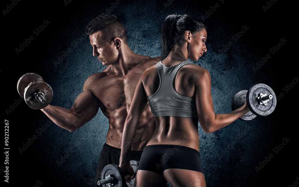 Wall mural athletic man and woman with a dumbells.