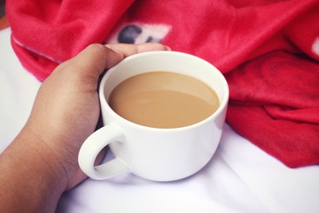 Drinking coffee on the bed