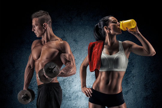 Athletic Man And Woman With A Dumbells.