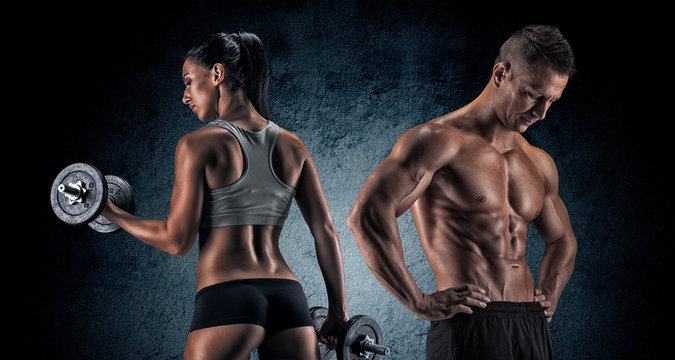 Athletic Man And Woman With A Dumbells.