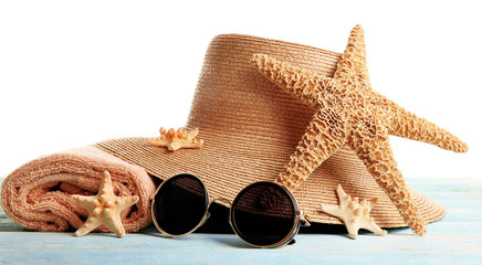 Naklejka premium Summer accessories on wooden table isolated on white