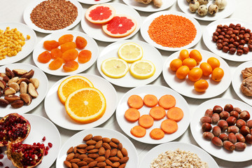 Set of orange products on wooden table, closeup