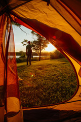 Photographer Looking at the Sunset while Camping