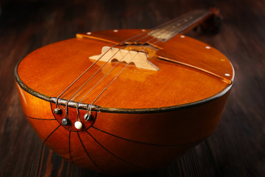 Folk musical instrument domra on wooden background