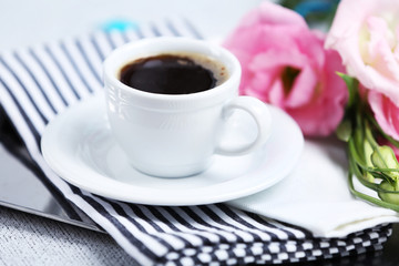 Cup of coffee with flowers on tray, closeup