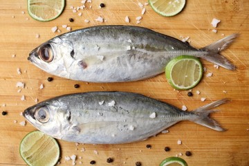 Fresh raw fish ,lemon ,salt and pepper