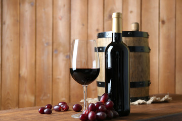 Beautiful still life with wine and grape on wooden table