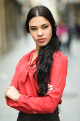 Hispanic stewardess in urban background