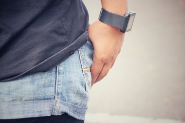 Smartwatch on hand with jeans pocket