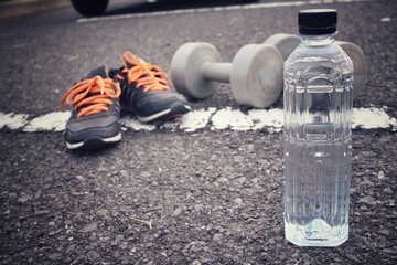 Sports set of sneakers dumbblell and water drink