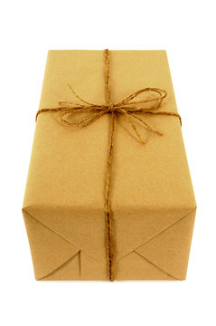 One single small brown paper package parcel tied with string isolated on white background photo vertical